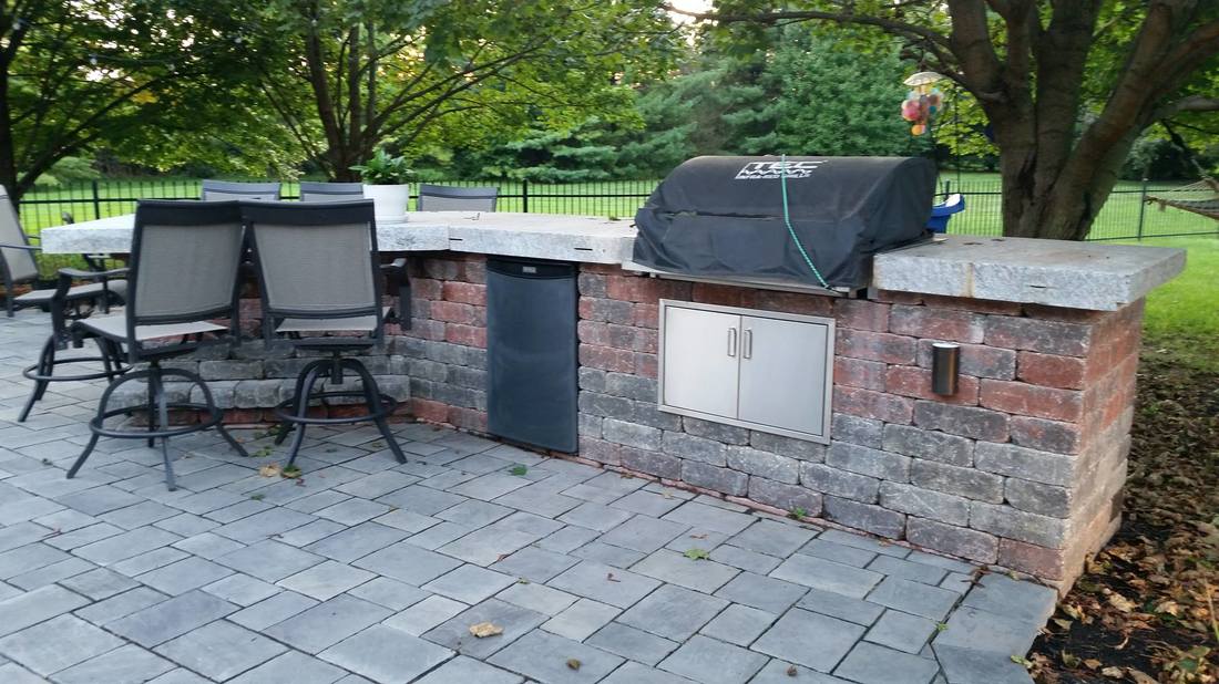 outside kitchen with a covered bbq grill